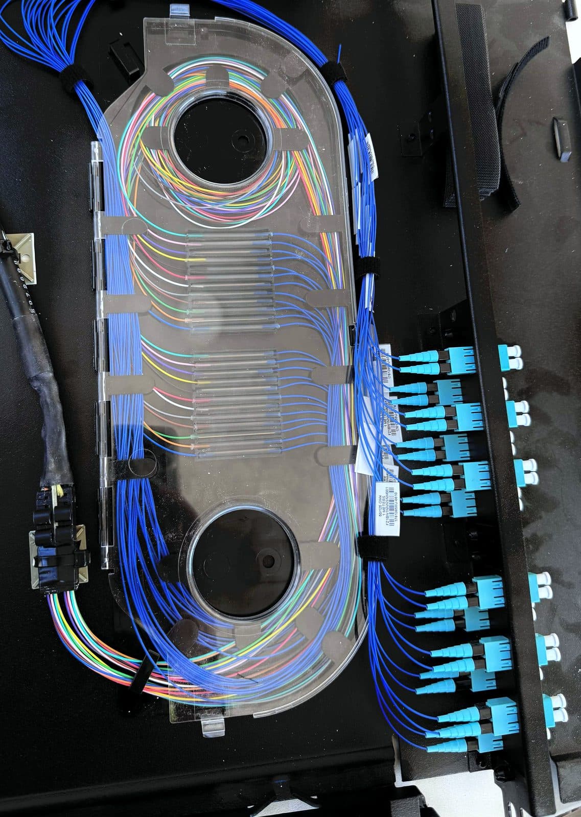Fotografía de instalación ERCONNECT: charola de empalmes con protectores termocontráctiles y pigtails OM4 terminados en adaptadores LC del panel